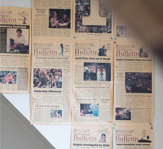 A woman stands with her arms crossed next to a window